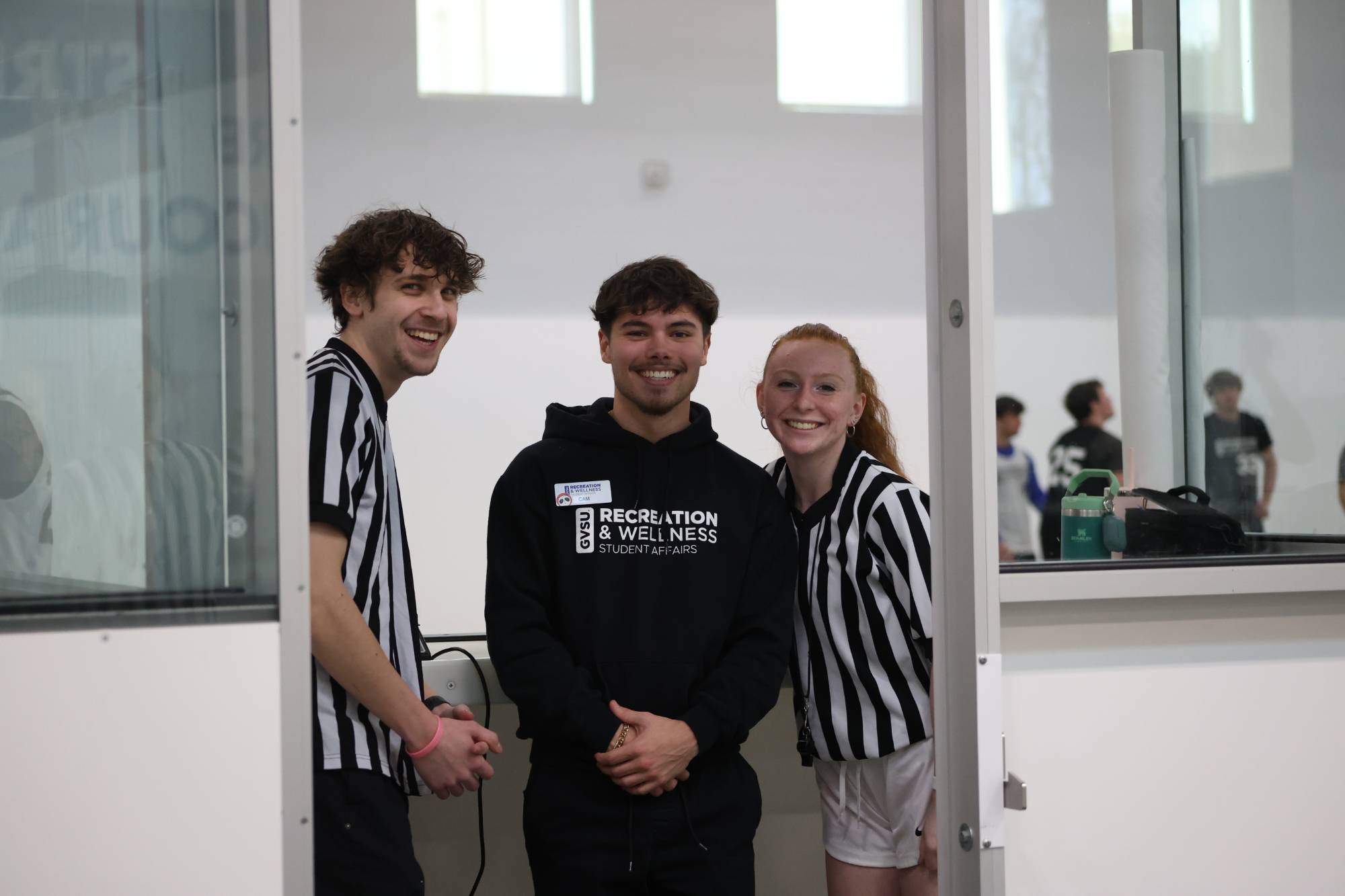 RecWell Student Staff at intramural sports. From left to right: referee, supervisor, referee